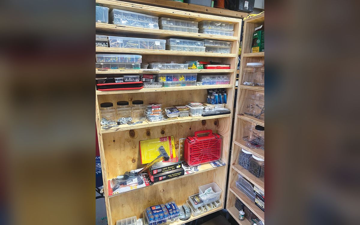 Rolling tool cabinet built on an old scaffolding frame, with shelves of bins and tools (FARM SHOW photo)